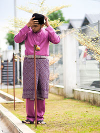 Woman holding umbrella while standing outdoors