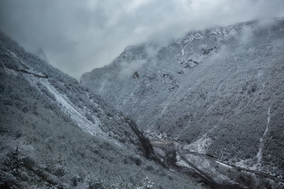 High angle view of snowcapped mountains against sky