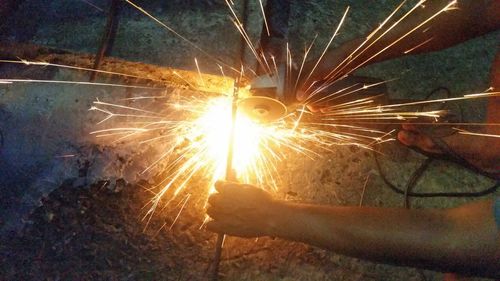 Close-up of hands working at night