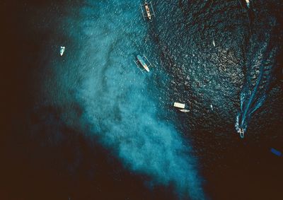 Aerial view of boats in sea at night