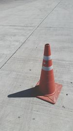 High angle view of traffic cone on road during sunny day