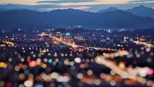 High angle view of illuminated cityscape at dusk