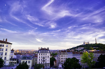 High angle view of buildings against cloudy sky