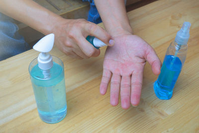 Close-up of hand holding bottle