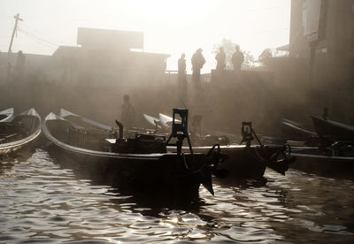 Silhouette of boats in city
