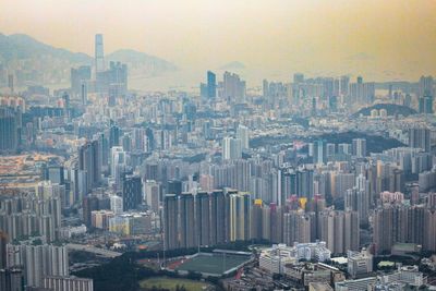 Aerial view of buildings in city against sky