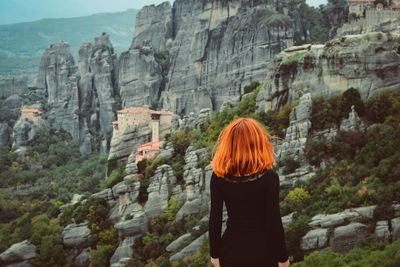 Rear view of woman walking on rock