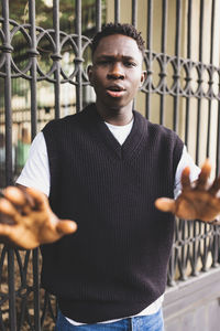 Portrait of young man standing in city