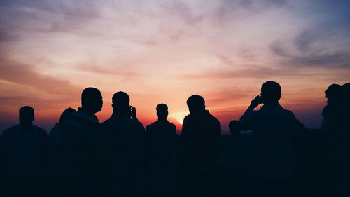 Silhouette of people at sunset