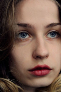 Close-up portrait of a young woman looking up thoughtfully