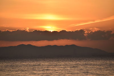 Scenic view of sea against romantic sky at sunset