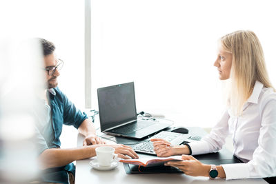 Business colleagues working at table