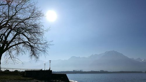 Scenic view of sea and mountains against sky