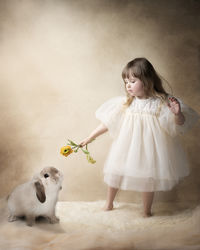 Side view of girl playing with dog