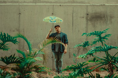 Portrait of smiling girl standing against plants