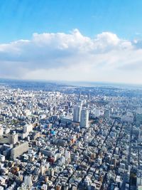 Aerial view of cityscape against sky