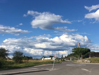 Country road against cloudy sky