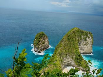 High angle view of rocks by sea against sky