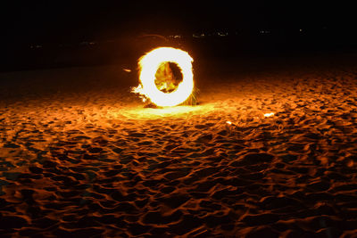 Light painting at beach against sky at night