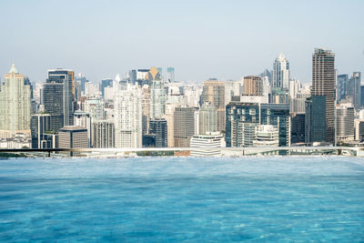 View of swimming pool against buildings in city