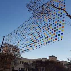 Low angle view of flags against sky