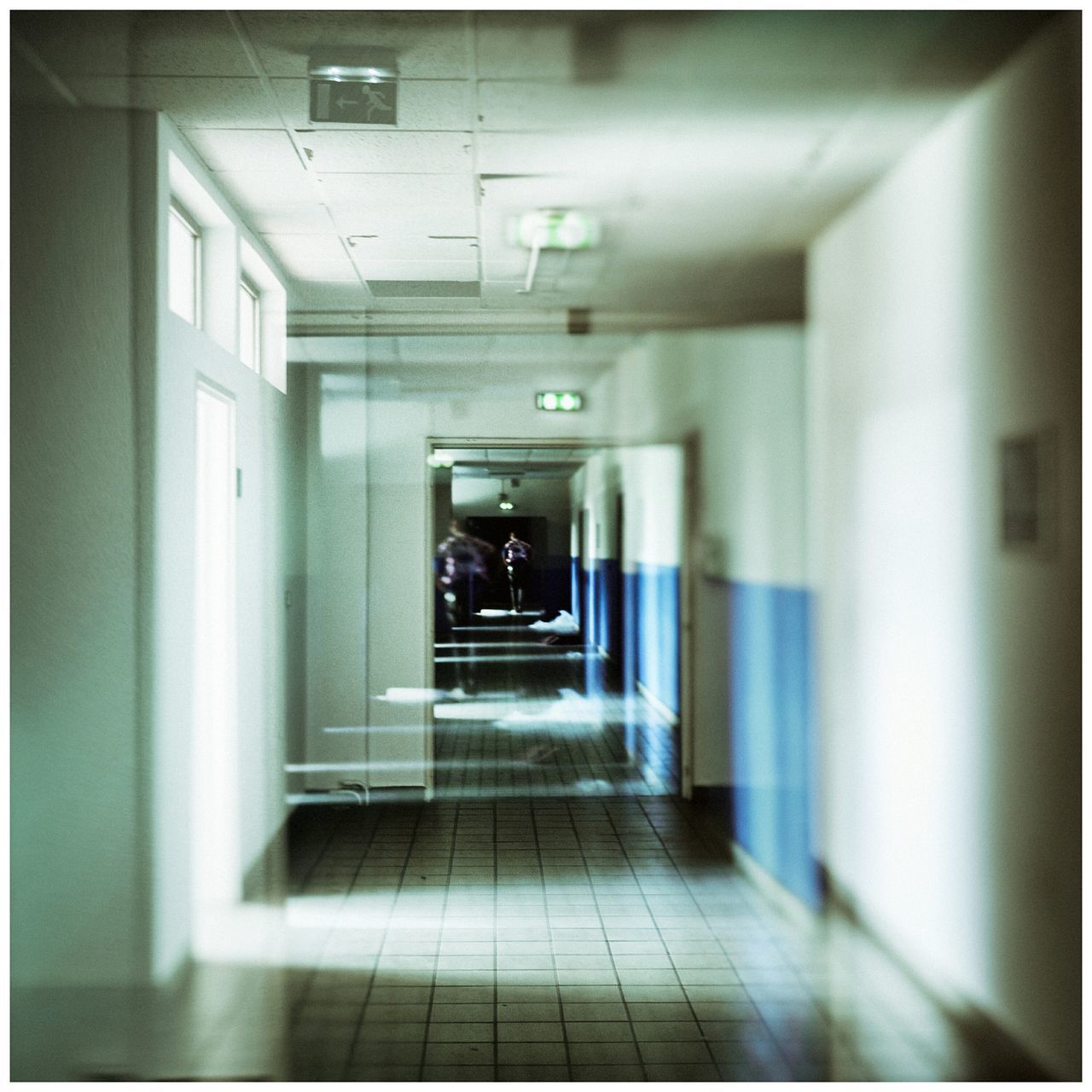 indoors, the way forward, architecture, corridor, built structure, transfer print, diminishing perspective, empty, illuminated, narrow, door, auto post production filter, building, absence, wall - building feature, wall, ceiling, flooring, tiled floor, no people