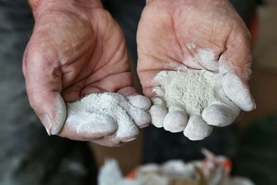 Close-up of hands holding cement