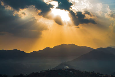 Scenic view of silhouette mountains against sky during sunset