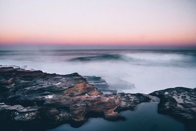 Scenic view of sea against clear sky during sunset