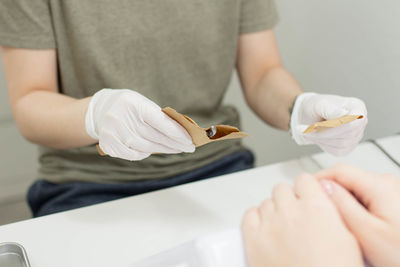 Midsection of woman working on table