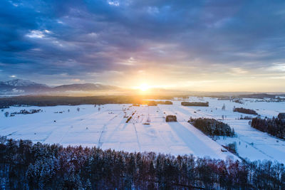 Scenic view of snow covered landscape during sunset