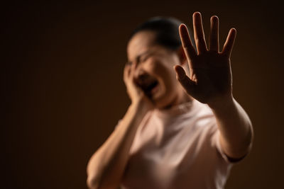 Portrait of shirtless man against black background