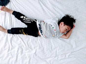 Directly above shot of boy lying on bed