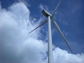 Low angle view of windmill against cloudy sky