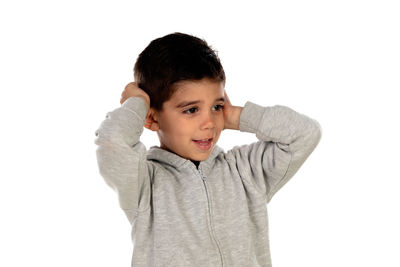 Portrait of boy standing against white background