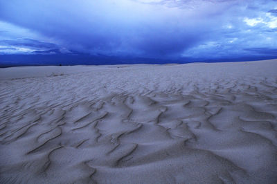 Scenic view of land during winter against sky