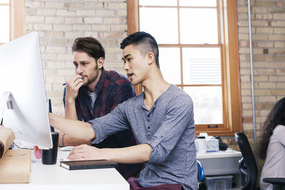 Business people discussing while working in office