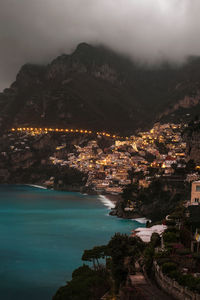 High angle view of townscape by sea against sky