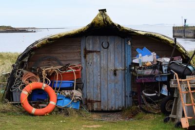 Abandoned house on field against sky