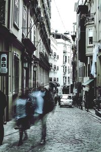 Blurred motion of people walking on street in city