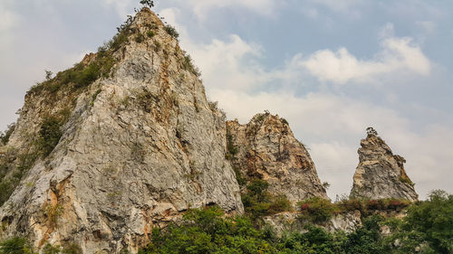 Low angle view of rock formation against sky