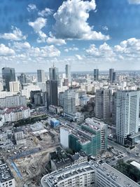 High angle view of modern buildings in city against sky