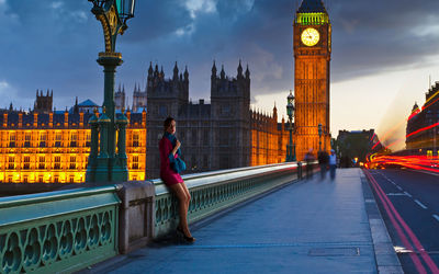 Woman standing on bridge in city