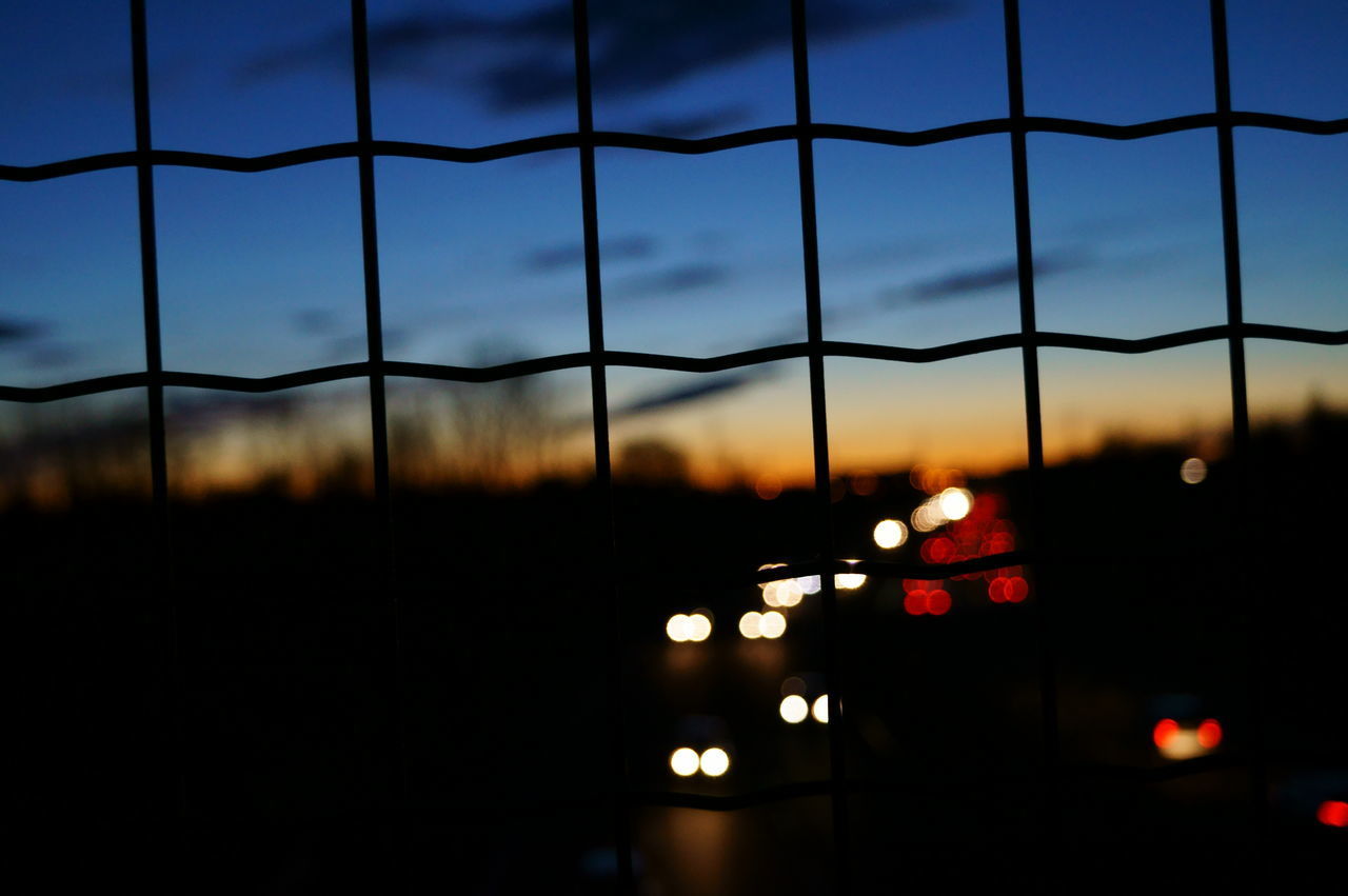 CLOSE-UP OF ILLUMINATED CITY AGAINST SKY