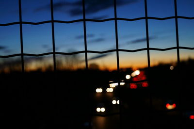 Close-up of illuminated city against sky during sunset