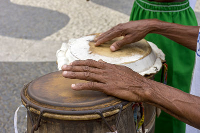 Percussionist playing a atabaque during cultural manifestation at pelourinho on salvador, bahia