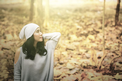 Thoughtful woman standing in forest