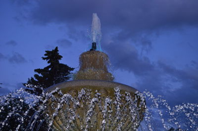 Low angle view of fountain against building