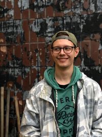 Portrait of smiling young man standing outdoors