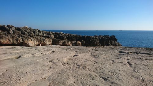 Scenic view of sea against clear blue sky